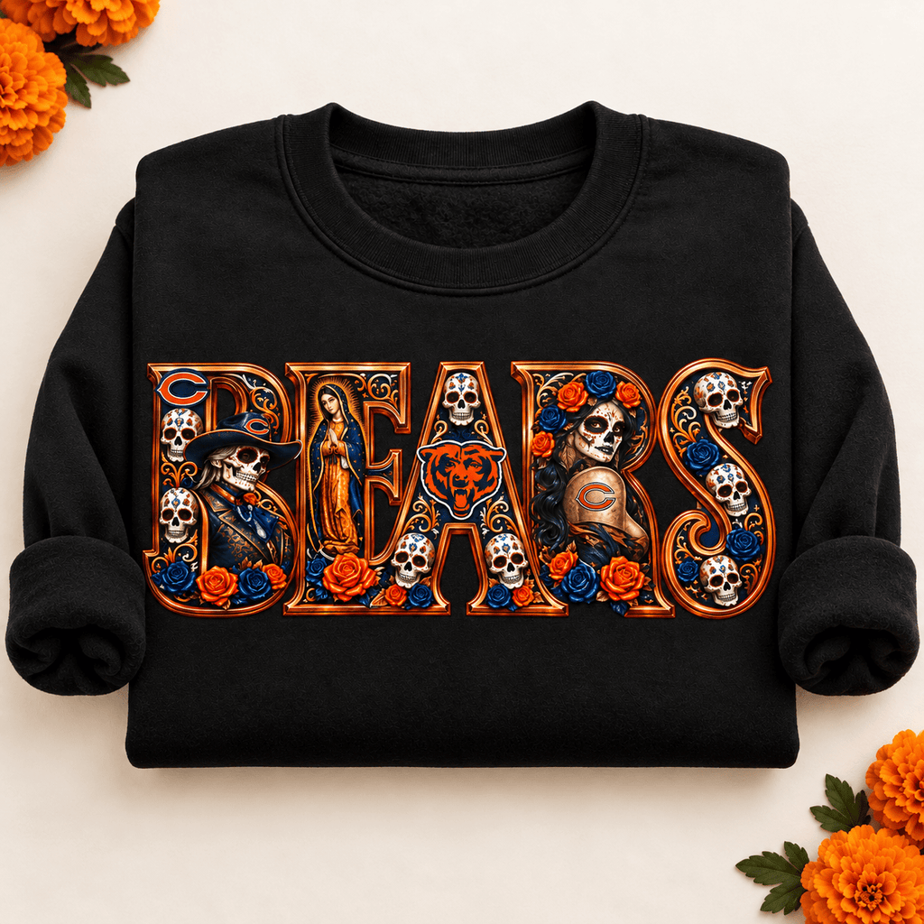 Folded black Chicago Bears Day of the Dead crewneck sweatshirt with rolled sleeves, sugar skull artwork and orange marigolds