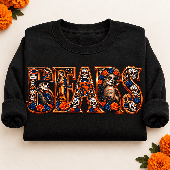 Folded black Chicago Bears Day of the Dead crewneck sweatshirt with rolled sleeves, sugar skull artwork and orange marigolds