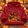 Freddy in Fall Halloween Hoodie — folded Antique Cherry Red with rolled sleeves and themed background