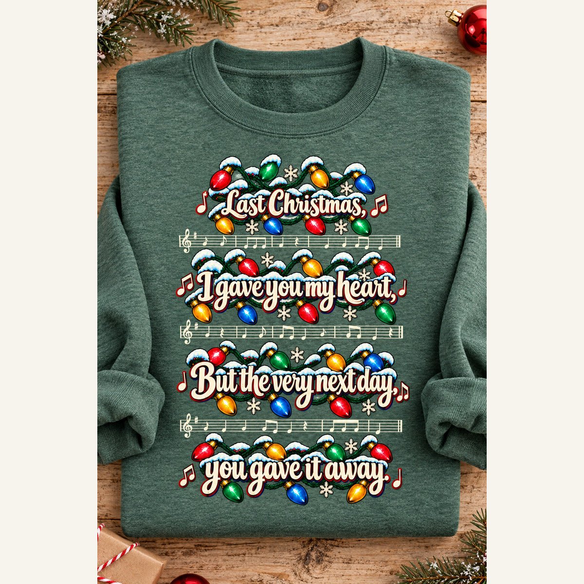 Last Christmas 2 Heather Dark Green sweatshirt folded with rolled sleeves