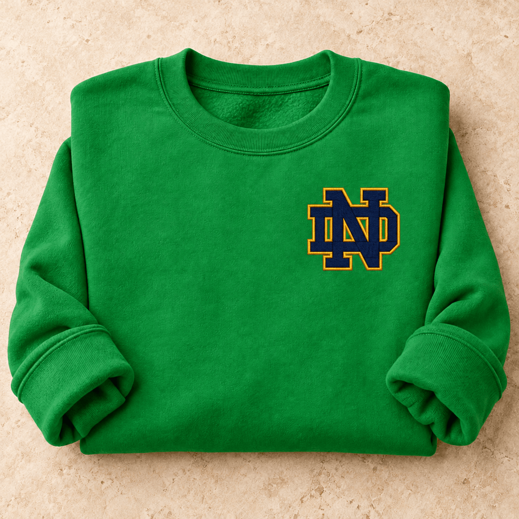 Irish Green Notre Dame Sweater folded with enlarged navy-and-gold embroidery-look print